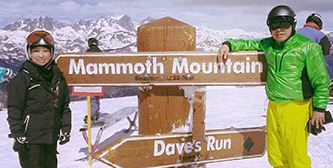 two people next to sign on snowy mountain 