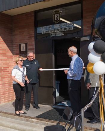 people outside of new medicine center cutting ribbon